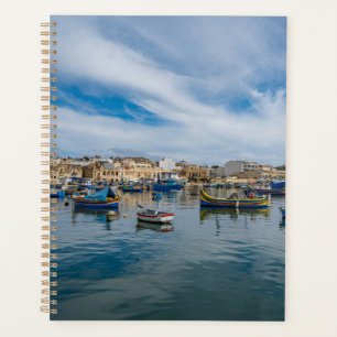 Traditional colorful fishing boats in the harbor planner