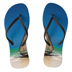 Traditional fishing boat on the beach jandals