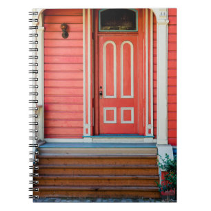 Traditional red painted wooden door and porchdoor, notebook