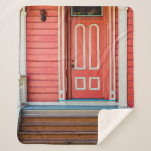 Traditional red painted wooden door and porchdoor, sherpa blanket
