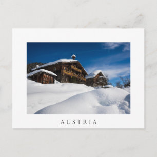 Traditional wooden cabins in de snow postcard