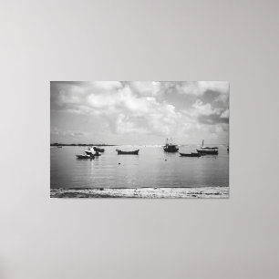 Tranquil Fishing Boats Floating on Calm Sea in Bla Canvas Print