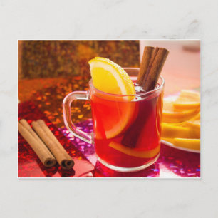 Transparent cup of tea with citrus, cinnamon postcard