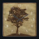 Tree Silhouette on Bronze Background Square Wall Clock<br><div class="desc">A bronze background serves as the scene for this silhouette of a tree with branches swaying in the breeze. You almost feel as if you could rest your back against this tree,  sit on the ground and take a long nap.</div>