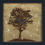 Tree Silhouette on Bronze Background Square Wall Clock<br><div class="desc">A bronze background serves as the scene for this silhouette of a tree with branches swaying in the breeze. You almost feel as if you could rest your back against this tree,  sit on the ground and take a long nap.</div>