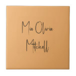 Trend Colour Soft Orange Name Ceramic Tile<br><div class="desc">Introducing the trendy spring shade: Soft Pastel Orange. Elevate your home decor with our modern and stylish ceramic tile, featuring a customisable name in a charming handwritten font in classic black, looking like a signature. Its elegant and minimalist design in solid colours exudes timeless appeal, making it perfect for personal...</div>