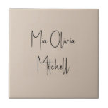 Trend Colour Soft Taupe Name Ceramic Tile<br><div class="desc">Introducing the classic spring shade: Soft Taupe. Elevate your home decor with our modern and stylish ceramic tile, featuring a customisable name in a charming handwritten font in classic black, looking like a signature. Its elegant and minimalist design in solid colours exudes timeless appeal, making it perfect for personal use...</div>