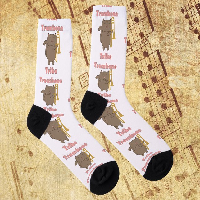 Trombone Tribe Kawaii Cat Pink Letters Socks (A pair of socks with a brown cat holding a trombone and the words trombone tribe in pink letters.)