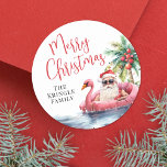 Tropical Beach Christmas Classic Round Sticker<br><div class="desc">Celebrate the season with this festive and playful round sticker design, perfect for adding a tropical touch to your holiday celebration. The artwork features a laid-back Santa Claus in sunglasses lounging in a pink flamingo floaty, surrounded by ocean waves and beachy vibes—bringing a fun twist to a warm-weather Christmas. "Merry...</div>