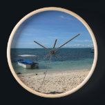 Tropical Blue Ocean Beach & Boat:Summer Wall Clock<br><div class="desc">Escape to a serene tropical paradise with this stunning photograph of a crystal-clear blue ocean and a peaceful boat resting near the shore. The pristine white sand and the gentle gradient of the sea create a calming, minimalist aesthetic. Perfect for adding a touch of summer vacation to your phone case,...</div>