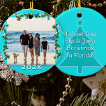 Tropical Christmas Beach Family Vacation  Ceramic Tree Decoration<br><div class="desc">Round ceramic Christmas ornament with a beach design of starfish and holly. Aqua blue background with a square photo template. White starfish, or sea stars, mingle with green holly to make the photo frame. Add the year beneath the photo. On the back, include more text over a Christmas tree image....</div>