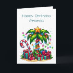 Tropical Christmas Palm Tree Card<br><div class="desc">Birthday card with a seasonal holiday image. A tropical palm tree decorated in festive lights with a star on top. A giant red and white candy cane sticking out of the sand. Gifts under the tree. Whimsical and fun.</div>