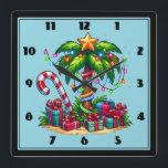 Tropical Christmas Palm Tree Square Wall Clock<br><div class="desc">A clock with a seasonal holiday image. A tropical palm tree decorated in festive lights with a star on top. A giant red and white candy cane sticking out of the sand. Christmas presents under the tree. Whimsical and fun.</div>
