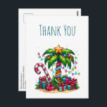 Tropical Christmas Palm Tree Thank You            Postcard<br><div class="desc">Thank you postcard with a seasonal holiday image. A tropical palm tree decorated in festive lights with a star on top. A giant red and white candy cane sticking out of the sand. Christmas presents under the tree. Whimsical and fun.</div>