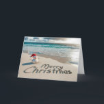 Tropical Christmas Snowman On a Beach Holiday Card<br><div class="desc">A small sand snowman wearing a Santa hat stands on a sandy beach with "Merry Christmas" written in the sand</div>