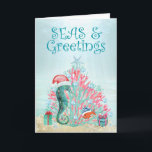 Tropical Coral Christmas Tree Seas and Greetings<br><div class="desc">Tropical, nautical themed holiday card features a "Christmas under the sea" whimsical scene with a cute seahorse wearing a Santa hat and a goldfish gathered around a coral Christmas tree topped by a starfish wishing you "Seas and Greetings". The greeting on the inside can be personalised (shown with "Warmest wishes...</div>
