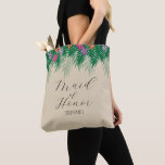 Tropical Flowers and Palm Branches Maid of Honour Tote Bag<br><div class="desc">This bridesmaid bag offers a graphic of bright coloured tropical flowers and green palm branches across the top of the bag. The words "Maid of Honour" appears in trendy hand written style text. To make this bag truly unique and personal,  you can also personalise it with your name.</div>