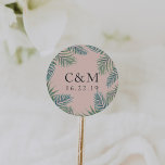 Tropical Foliage Wedding Monogram Classic Round Sticker<br><div class="desc">Island chic stickers in green watercolor are the perfect finishing touch for your wedding invitations or favours. Design features tropical palm frond leaves encircling your initials and wedding date,  on a beachy blush pink background. Ideal for summer,  beach,  or destination weddings.</div>