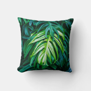 Tropical green leaves on dark background, nature s cushion