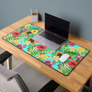 Tropical mix-fruit, flowers and leaves on blue desk mat
