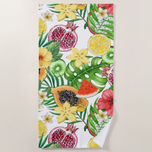 Tropical mix-fruit, flowers and leaves on white beach towel