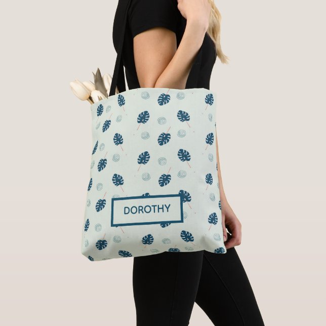 Tropical monstera leaves monogram on blue tote bag (Close Up)