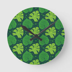 Tropical pattern with liana and monstera leaves round clock