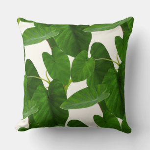 Tropical plant green leaves on ivory cushion