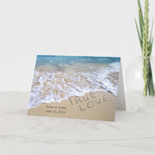 true love text in ocean sand wedding card