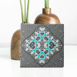Turquoise Black White Geometric Dynamic Lines  Tile<br><div class="desc">This ceramic tile showcases a captivating blend of modern and timeless aesthetics. The background features a dynamic pattern reminiscent of zebra stripes, with alternating black and white lines of varying thicknesses. This creates a visually striking backdrop for the symmetrical geometric pattern at the centre of the tile. The central pattern...</div>
