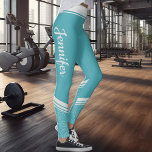 Turquoise floral white stripes & name modern leggings<br><div class="desc">These turquoise modern workout leggings feature an elegant white floral design on the ankles and calves and white stripes on the waistband.
Easily customisable by adding your name on both sides on a calligraphy white font.</div>