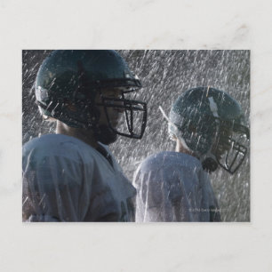 Two American football players in rain, side view Postcard