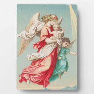 Two angels wear a small child plaque