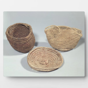 Two baskets and a cover (woven palm fronds) plaque