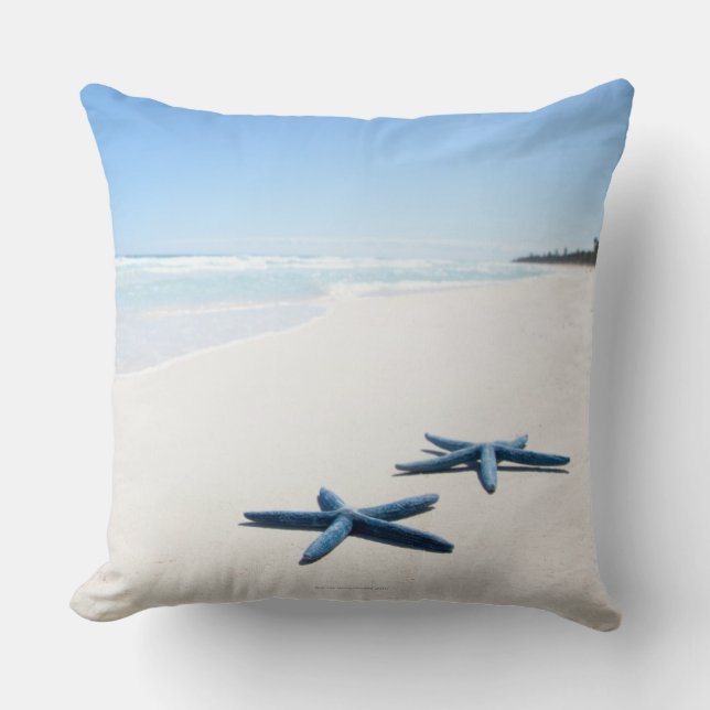 Two blue starfish at water's edge on tropical 2 cushion (Front)