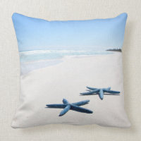 Two blue starfish at water's edge on tropical 2