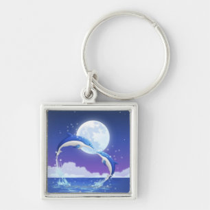 Two bottle-nosed dolphins jumping out of water key ring