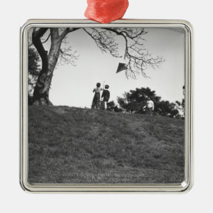 Two boys flying kite on hill B&W Metal Tree Decoration