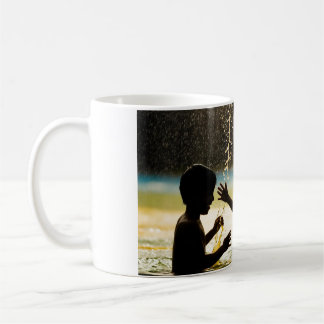Two boys playing in a waterfront coffee mug