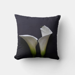 Two calla lilies on black cushion