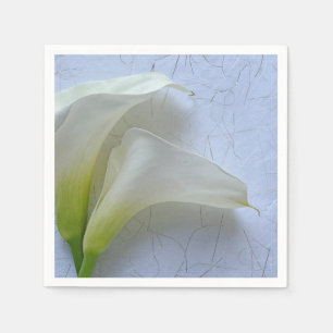 Two calla lilies on textured paper napkin
