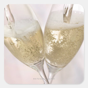 Two champagne flutes being filled with sparkling square sticker