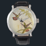 Two Colourful Hummingbirds Aiming for Same Flower Watch<br><div class="desc">Artist John Gould was passionate about birds. In this coloured drawing,  the two hummingbirds and the flower are represented beautifully. The details in this colourful fine art will delight any art lover.</div>