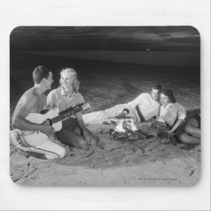 Two couples on beach sitting around campfire mouse pad