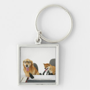 Two dogs wearing tie and glasses ,sitting on 2 key ring