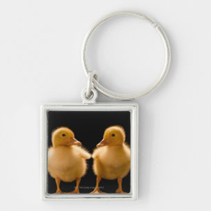 Two ducklings looking at one another key ring