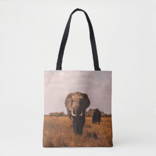 TWO ELEPHANTS WALKING ON GRASS COVERED GROUND TOTE BAG