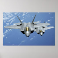 Two F-22 Raptors fly over the Pacific Ocean