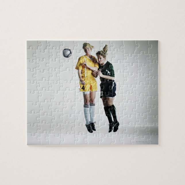 Two female soccer players in mid air heading jigsaw puzzle (Horizontal)