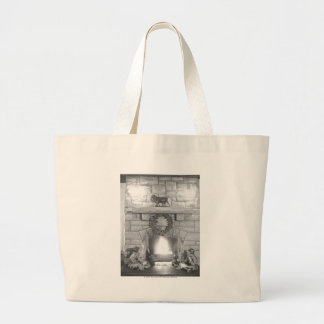 Two girls sitting by a fireplace at Christmas Large Tote Bag